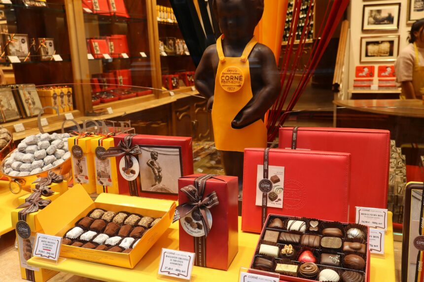 Assorted Swiss chocolate truffles in an open gift box with a ribbon — a luxury chocolate gift