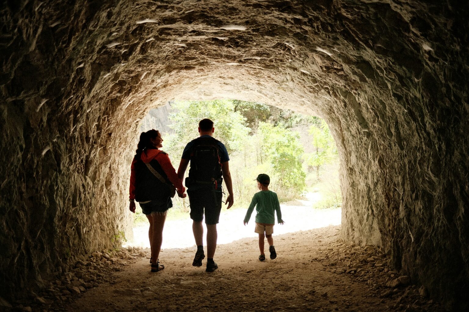A family hiking together on a forested trail — active family travel