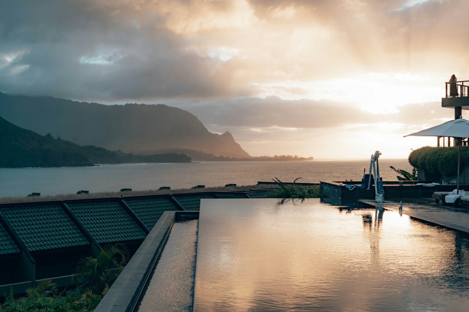 An infinity pool overlooking a sunset coastline — luxury travel rewards careful itinerary design