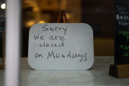 Closed retail storefronts on a quiet European Sunday street — most continental European countries restrict Sunday trading by national law