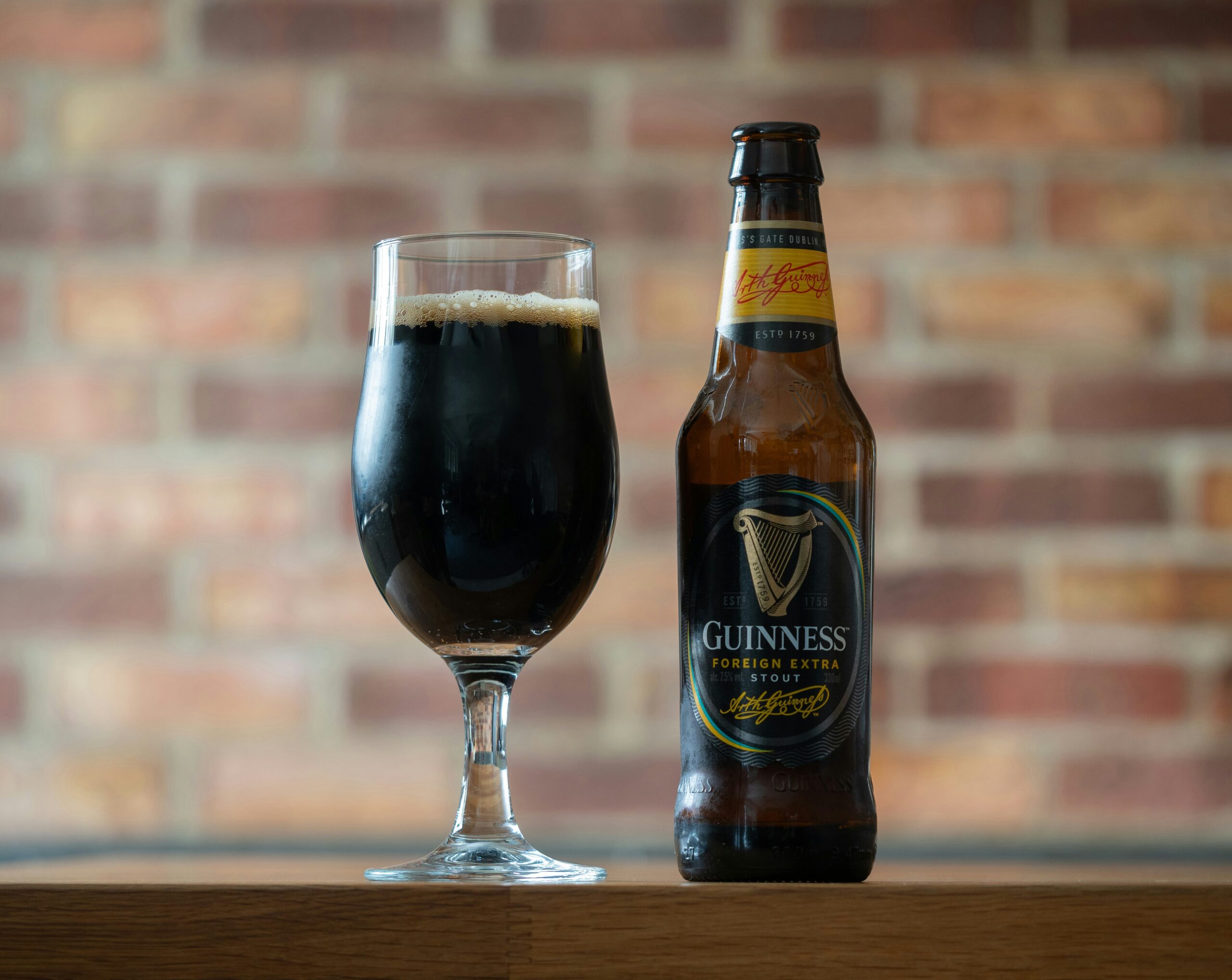 A pint of Guinness on a wooden bar
